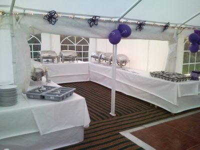 Chafing dishes in catering marquee connected to the main marquee