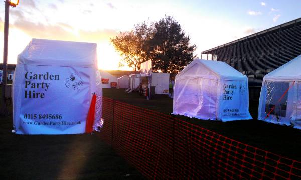 Two small marquees with Garden Party Hire branding