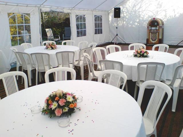 Covered tables and chairs with flower centre pieces
