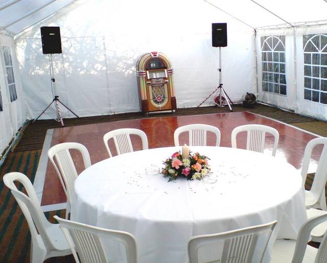 Dance floor in a marquee with tables and chairs