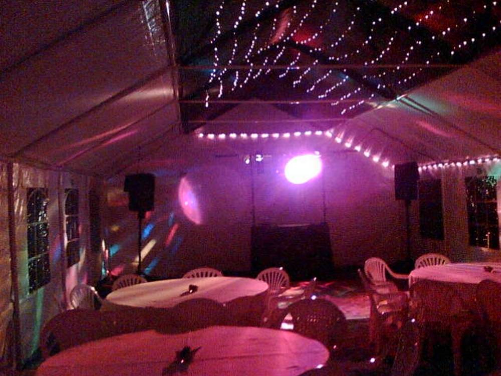 Rope light and starlight lining in a marquee with disco rig