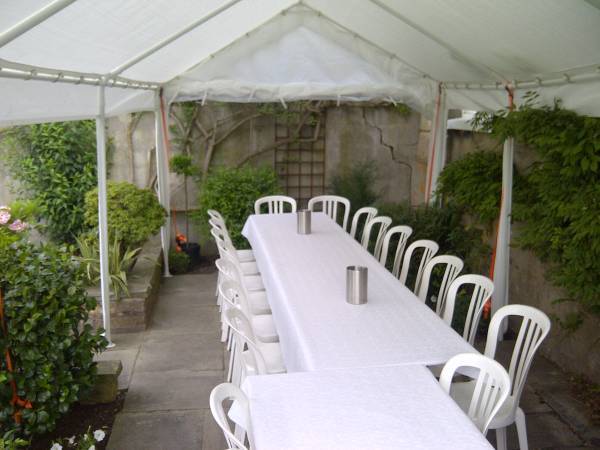 Two long tables with chairs inside a marquee