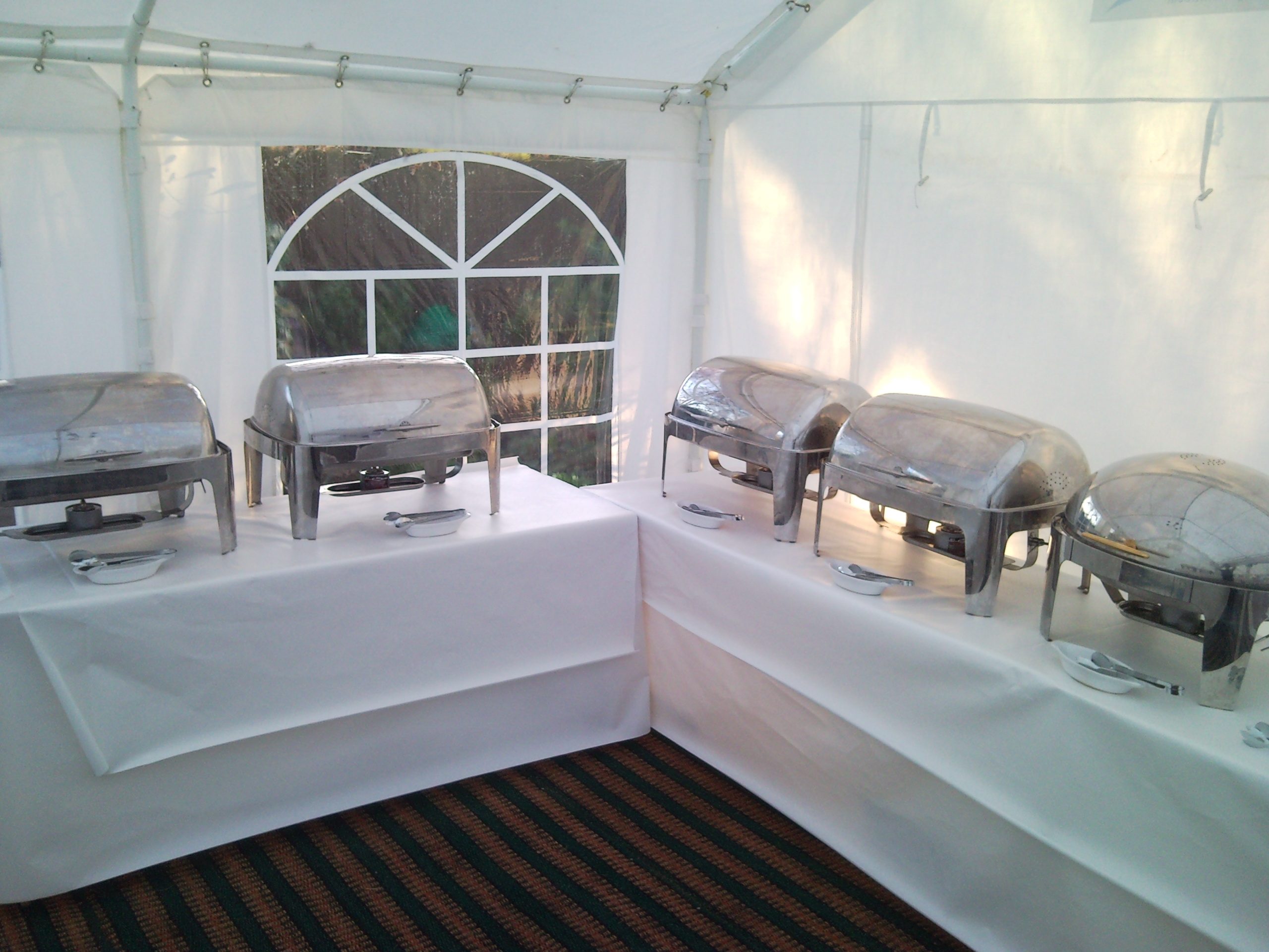 Chafing dishes on covered trestle tables