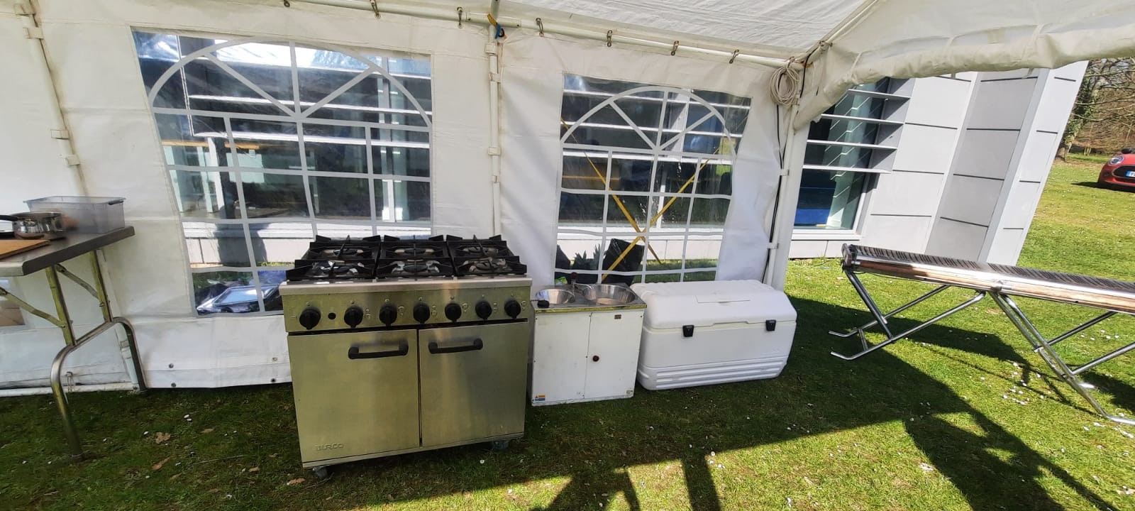 6 Burner gas range oven with cool box inside a marquee