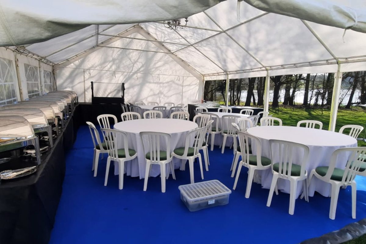 Full inside of a marquee with chafing dishes and table and chairs